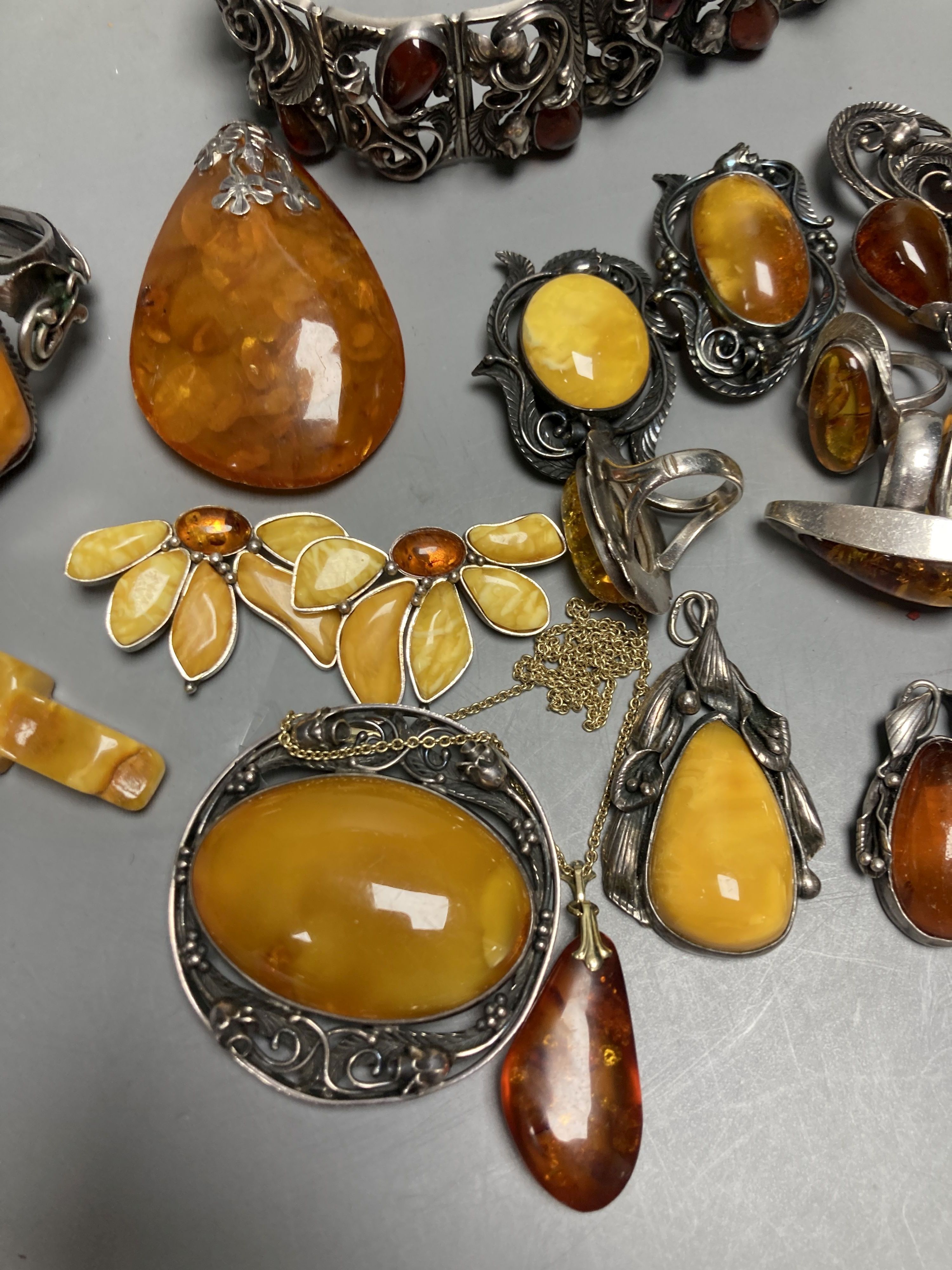 A mixed group of amber jewellery including white metal mounted bangle and Portuguese 925 bracelet.